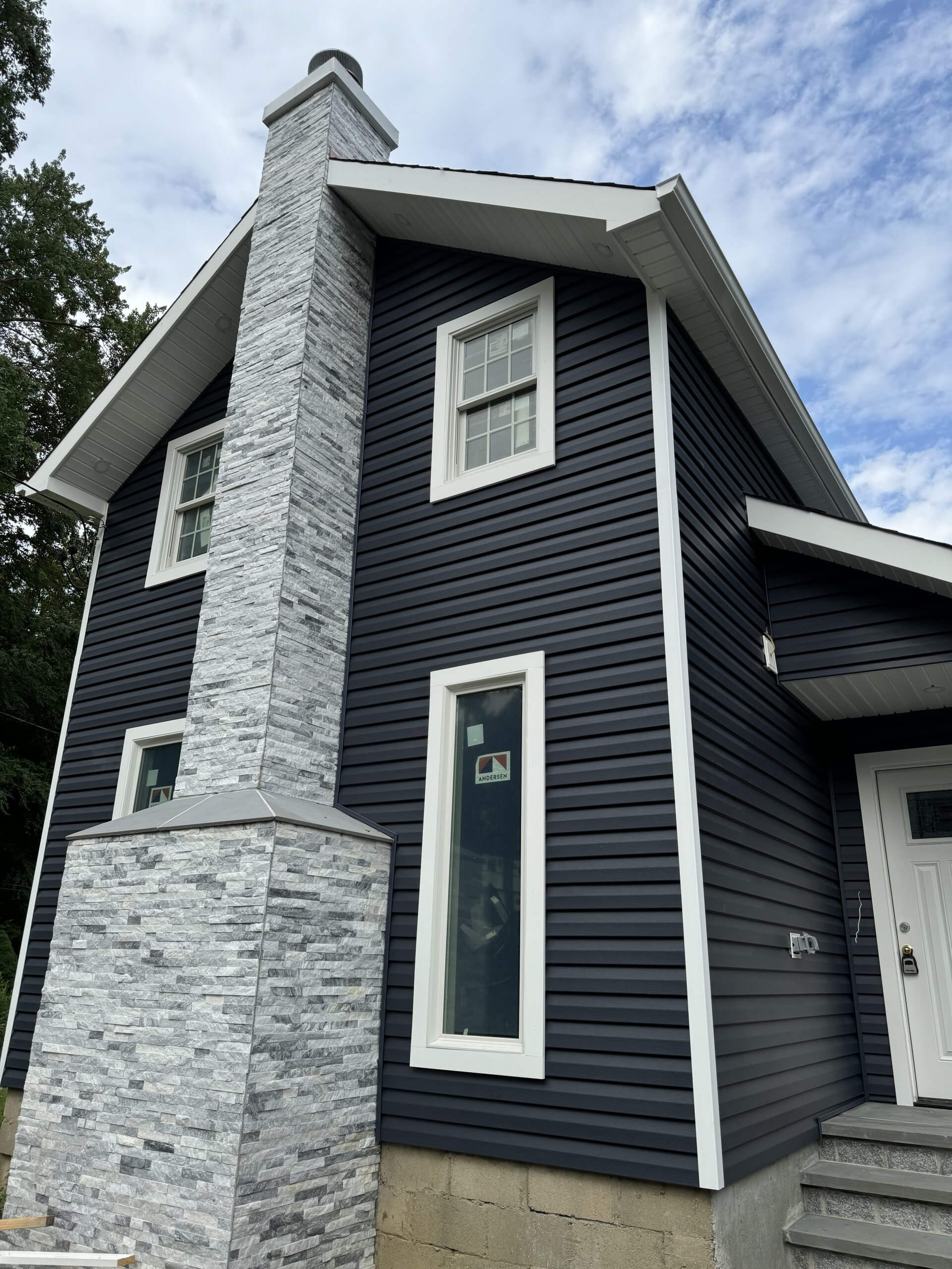 Newly installed siding on a residential home showcasing modern design and improved curb appeal in New York.