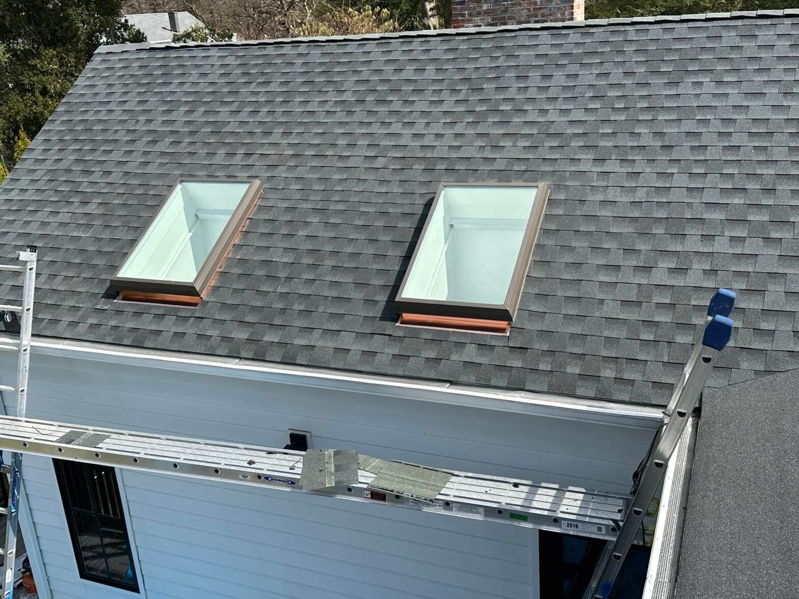 New skylight installed on a residential roof, enhancing natural light and energy efficiency