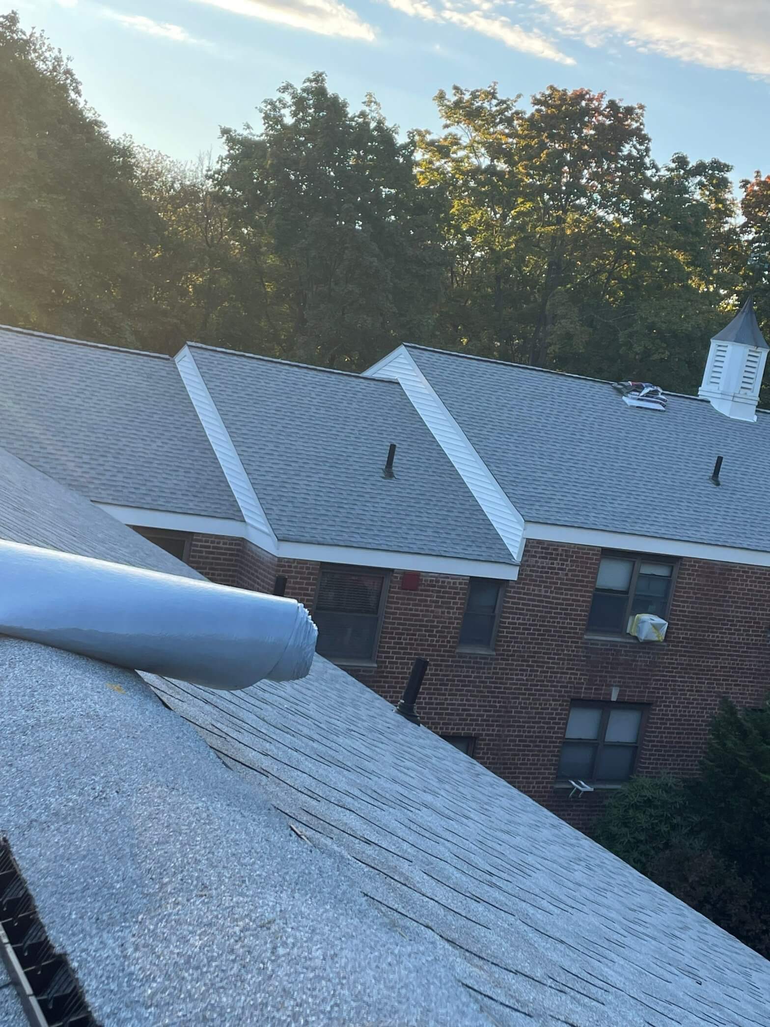 Country club roofing installation showcasing high-quality materials under a clear blue sky