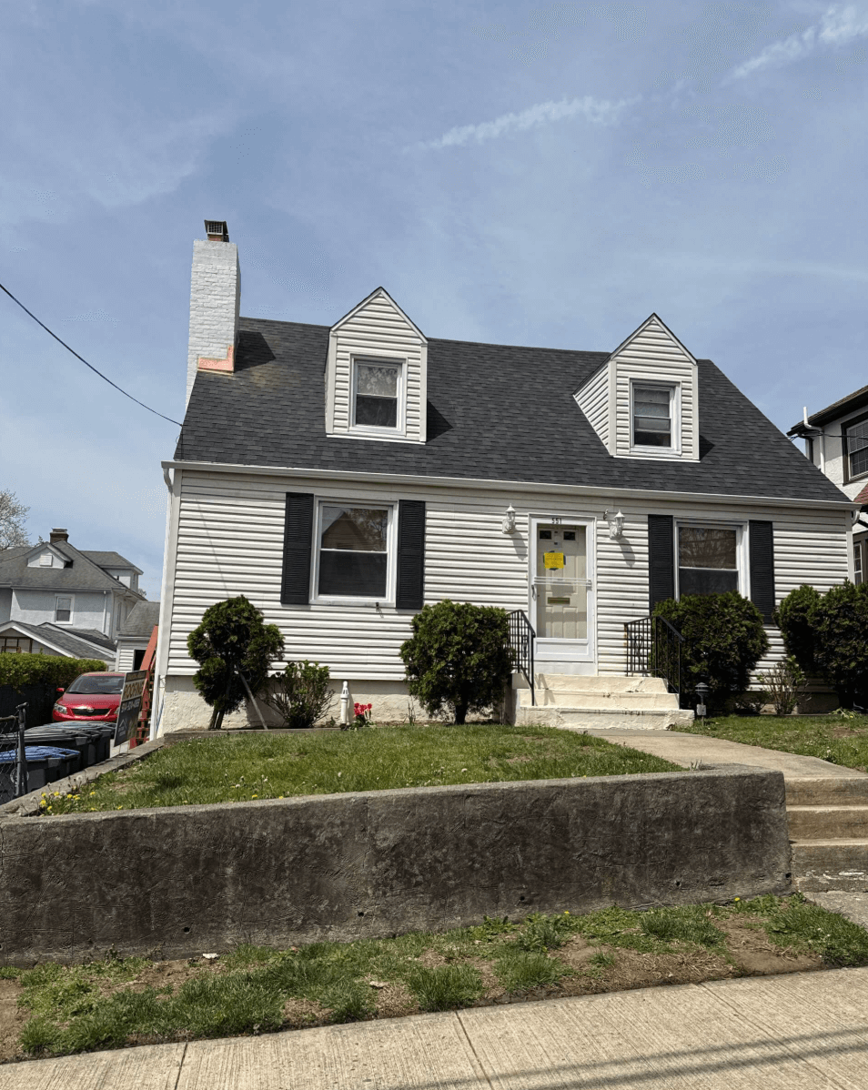 New residential roofing installation showcasing modern shingles and a clear blue sky in New York.