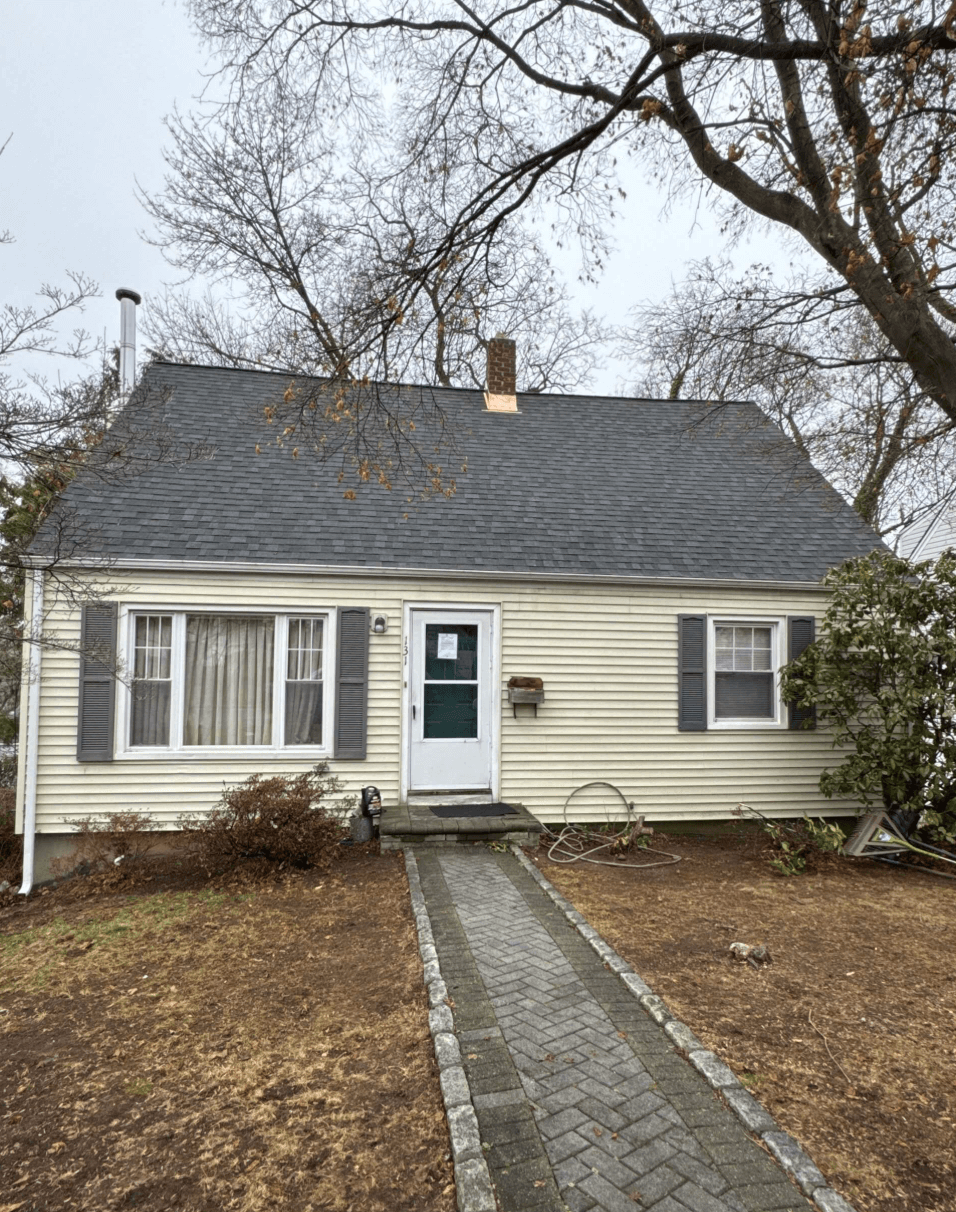 Newly installed black shingle roof on a residential home, showcasing quality craftsmanship and modern design in New York.