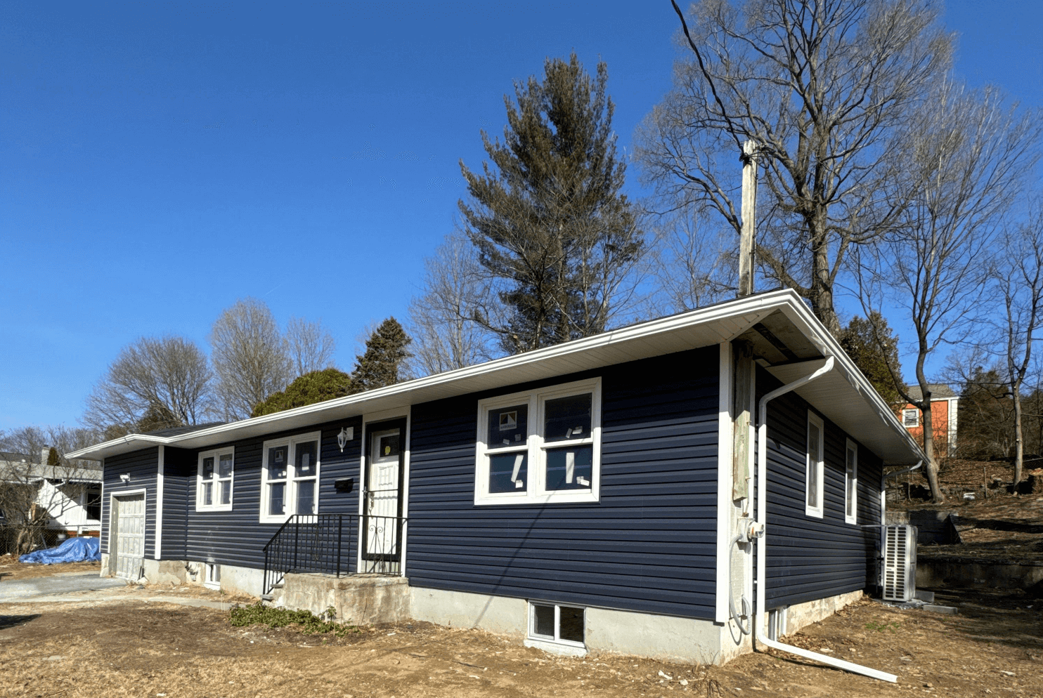 Dark blue new vinyl siding installation